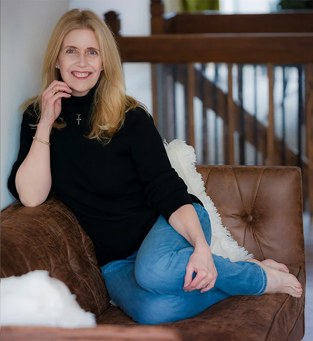 Joanne K. Gentile sitting on a leather sofa